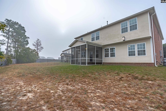 back of house featuring a sunroom and a yard