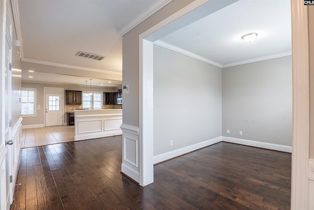 unfurnished living room with crown molding and dark hardwood / wood-style flooring