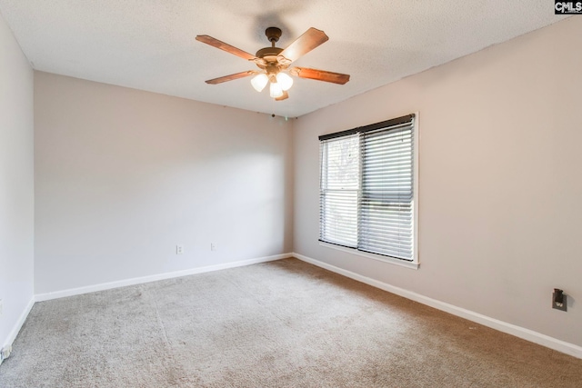 empty room with a textured ceiling, carpet floors, and ceiling fan