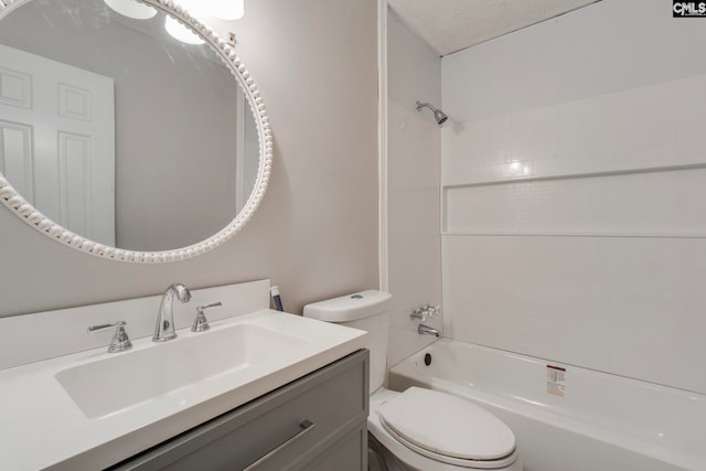 full bathroom featuring vanity, washtub / shower combination, toilet, and a textured ceiling