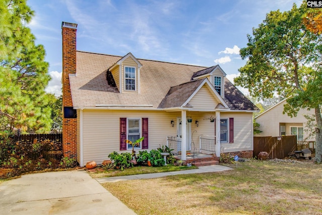 cape cod home with a porch and a front lawn