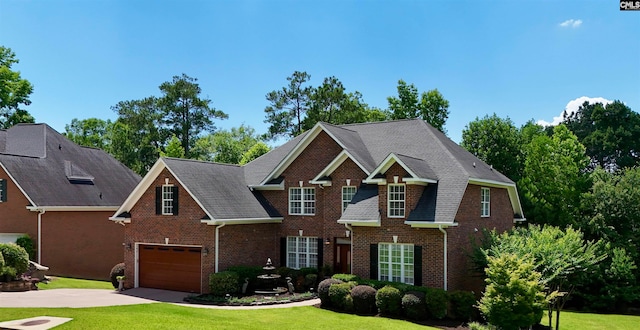 view of front of home featuring a garage and a front lawn