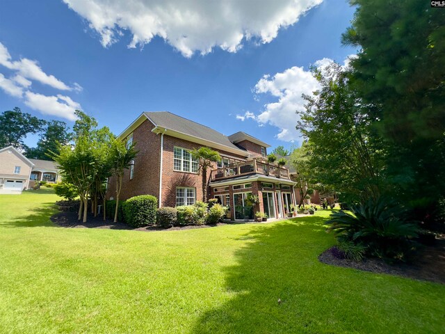 rear view of property featuring a yard