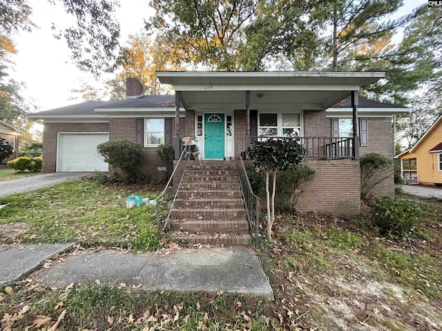 view of front of property with a garage and covered porch