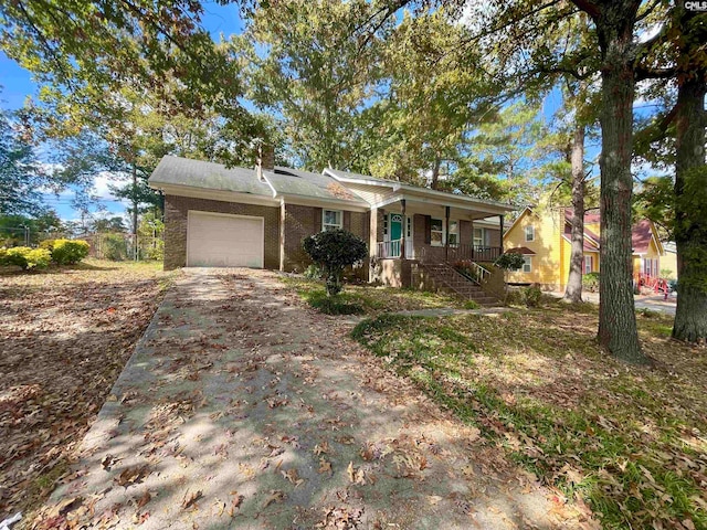 ranch-style home with a porch and a garage