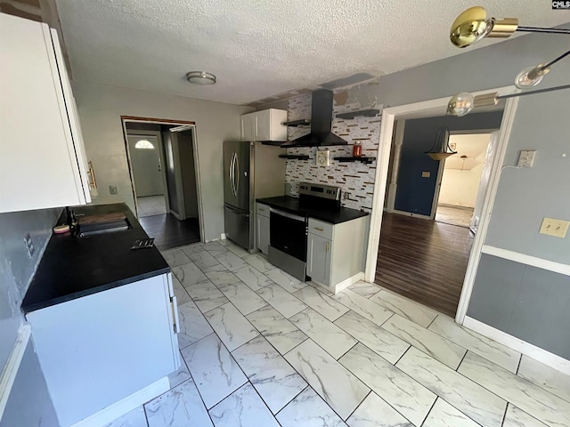 kitchen featuring stainless steel appliances, sink, a textured ceiling, extractor fan, and white cabinetry