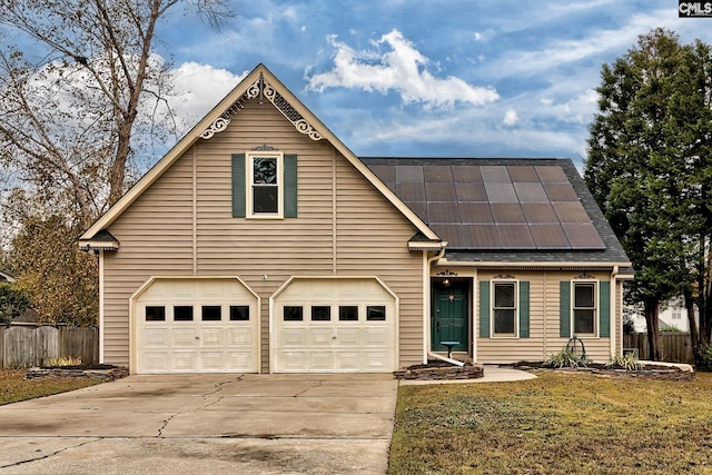 front of property with a garage, a front yard, and solar panels