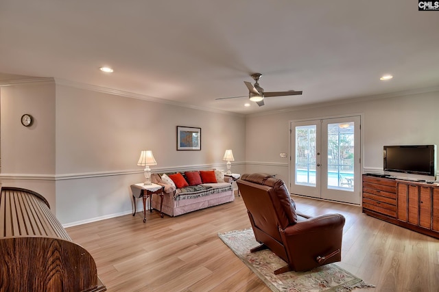 living room with light wood-type flooring, french doors, ceiling fan, and ornamental molding