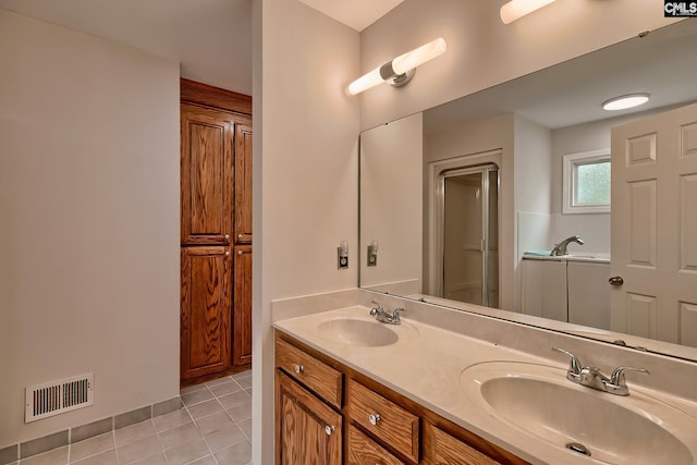 bathroom featuring tile patterned flooring and vanity