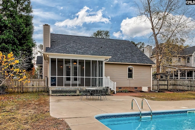 rear view of house featuring a patio area, a sunroom, and a fenced in pool