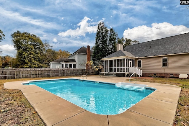 view of pool with a patio and a sunroom