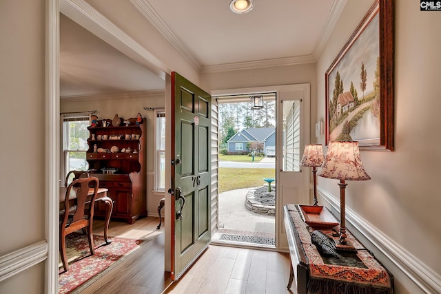 entryway featuring light hardwood / wood-style flooring, a healthy amount of sunlight, and crown molding