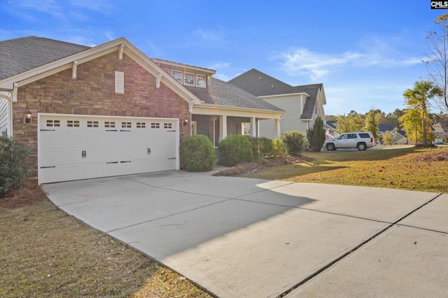 view of front of property featuring a front yard and a garage