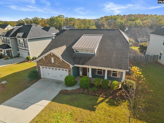 view of front facade featuring a porch, a front lawn, and a garage