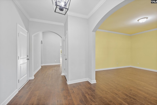 hall with dark wood-type flooring and crown molding