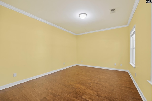 spare room with wood-type flooring and ornamental molding