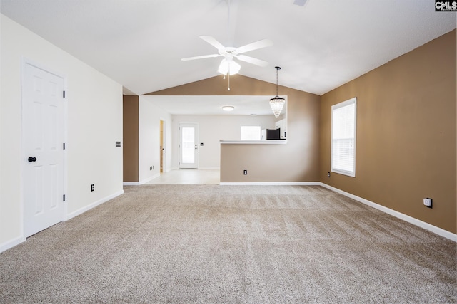 unfurnished living room featuring ceiling fan, light carpet, and vaulted ceiling