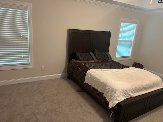 bedroom featuring light colored carpet and ornamental molding