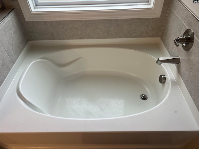 room details featuring a tub to relax in