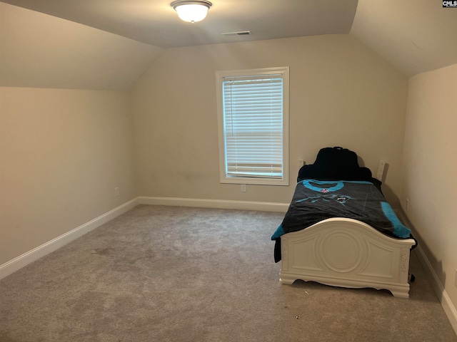 additional living space featuring light colored carpet and lofted ceiling