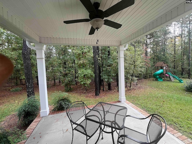 view of patio with a playground and ceiling fan