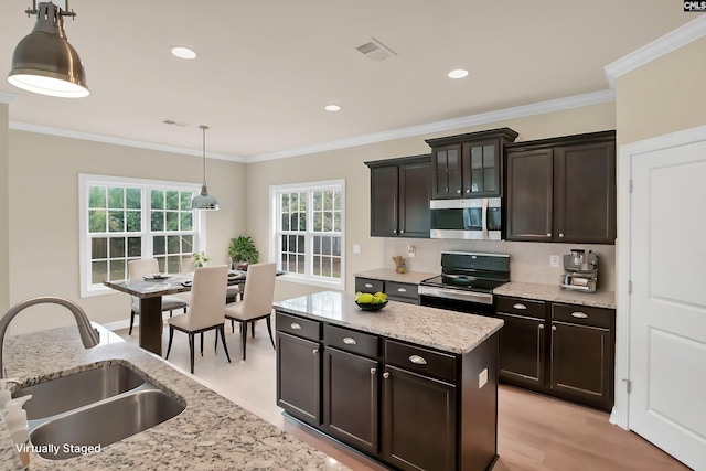 kitchen featuring black stove, ornamental molding, decorative light fixtures, dark brown cabinets, and sink