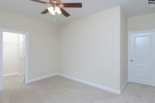 carpeted empty room featuring ceiling fan