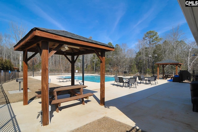 view of patio / terrace featuring a community pool and a gazebo