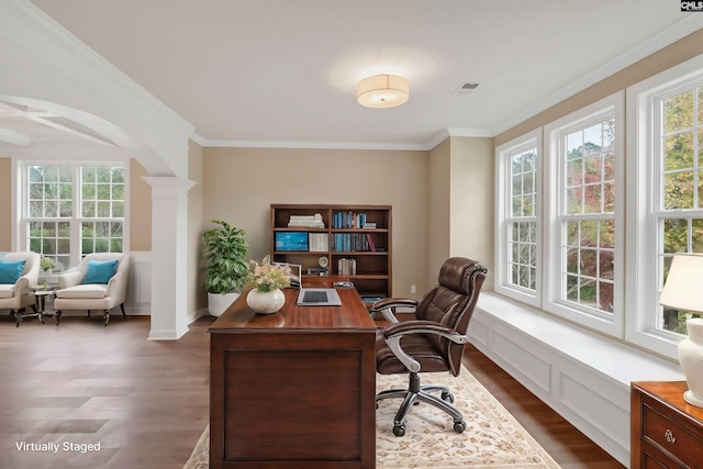 home office with dark wood-type flooring, ornamental molding, and ornate columns