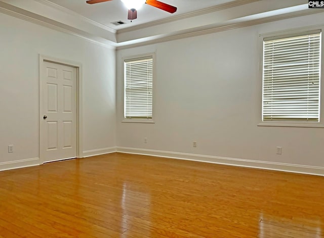 spare room with wood-type flooring, ceiling fan, and crown molding