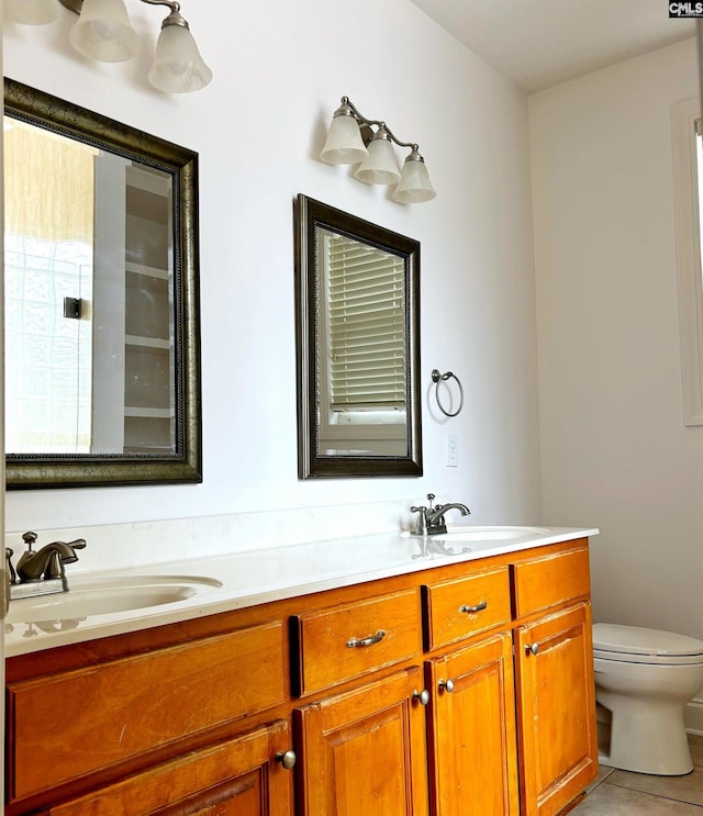 bathroom with tile patterned flooring, vanity, and toilet