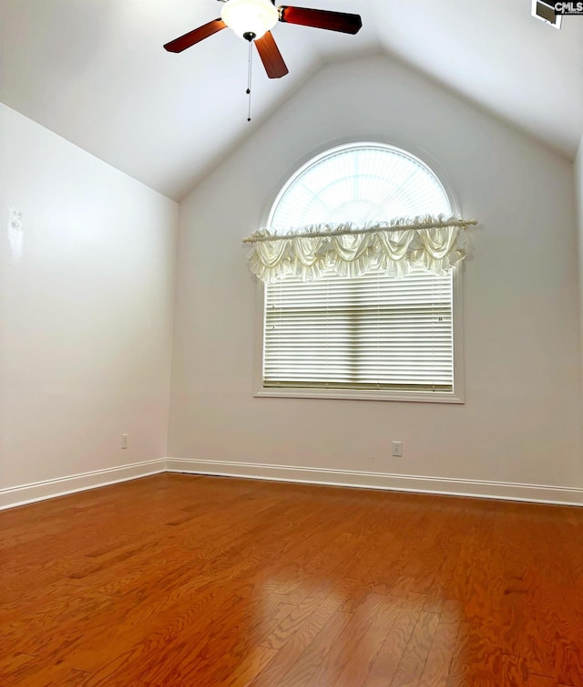 spare room with ceiling fan, wood-type flooring, and lofted ceiling