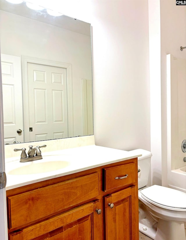 full bathroom featuring shower / bathing tub combination, vanity, and toilet