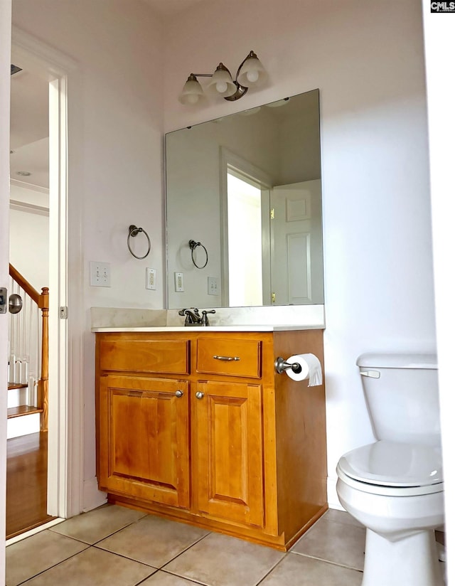 bathroom featuring toilet, vanity, and tile patterned flooring