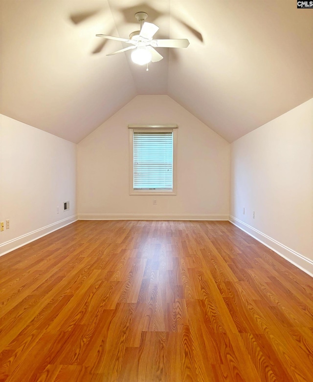 additional living space featuring light wood-type flooring, lofted ceiling, and ceiling fan