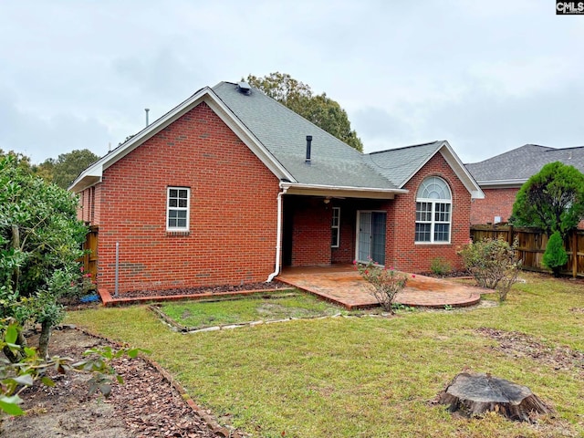 view of front of house with a front yard and a patio