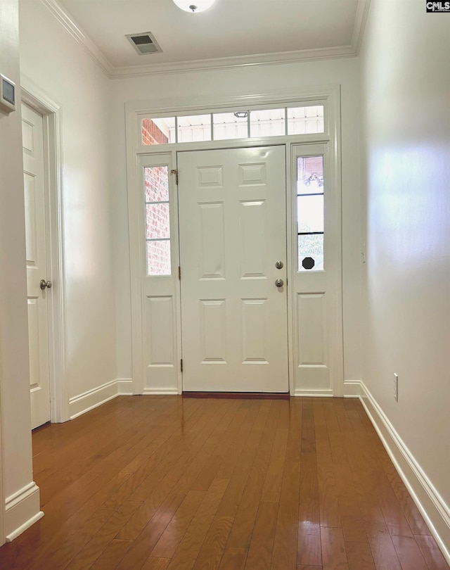 foyer featuring dark wood-type flooring and ornamental molding