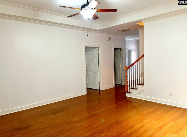 spare room featuring hardwood / wood-style flooring, ceiling fan, and crown molding