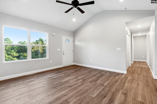 interior space featuring ceiling fan, light hardwood / wood-style flooring, and vaulted ceiling