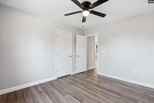 unfurnished bedroom featuring ceiling fan and light hardwood / wood-style floors