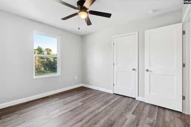 unfurnished bedroom featuring ceiling fan and light hardwood / wood-style flooring