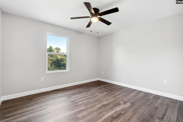 empty room with dark hardwood / wood-style floors and ceiling fan