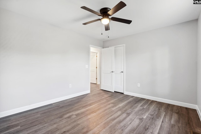 empty room featuring hardwood / wood-style flooring and ceiling fan