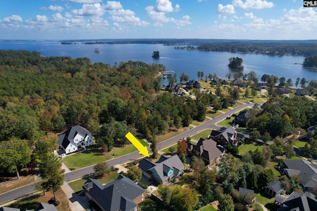 aerial view with a water view, a forest view, and a residential view