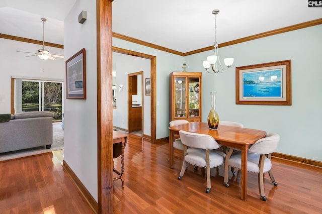 dining room with ornamental molding, hardwood / wood-style floors, and ceiling fan with notable chandelier