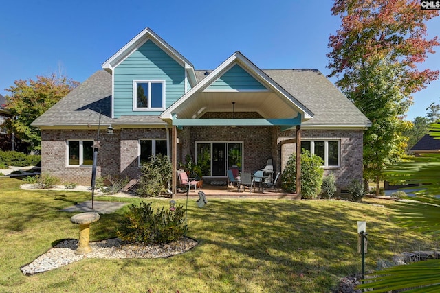 back of property with a lawn and a patio