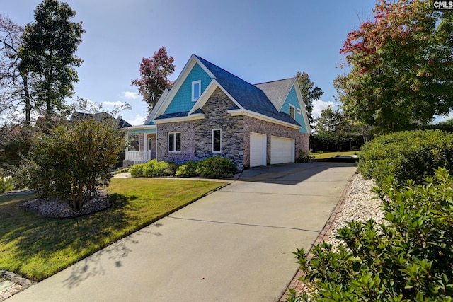 craftsman inspired home featuring a garage and a front yard