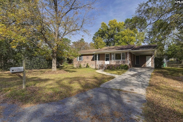 2017 Wellington Rd, Cayce, SC 29033 - single story home featuring asphalt driveway, covered porch, a carport, a front yard, and brick siding