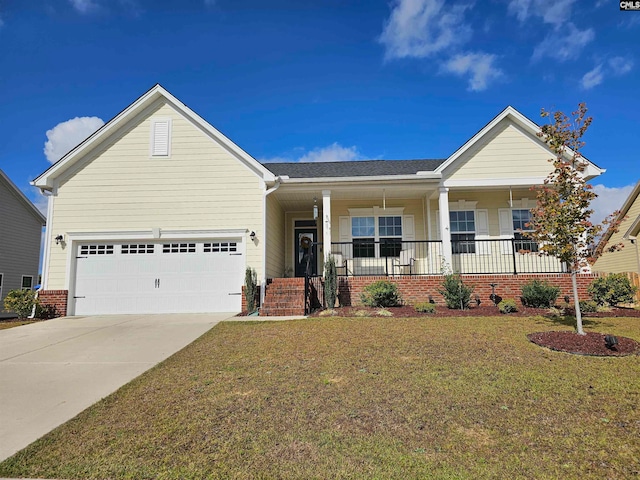 view of front of home featuring covered porch, a garage, and a front yard