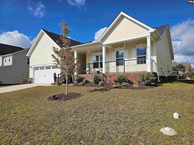 craftsman-style home featuring a front lawn, covered porch, central AC unit, and a garage